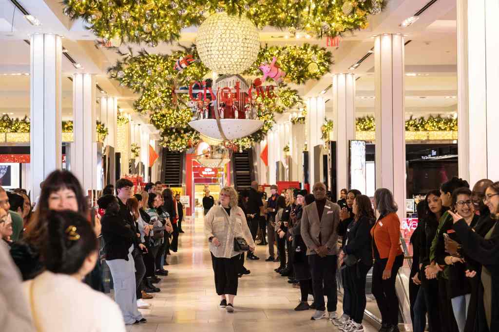 Employees welcome customers before Macy's opening in New York City on Black Friday on Nov. 24, 2023.