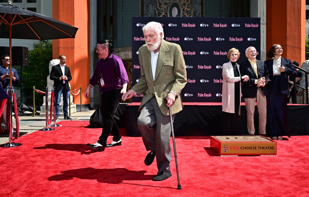 Dick Van Dyke walks with his cane after posing with US comedian and actress Carol Burnett during her Hand and Footprint ceremony in the courtyard of the TCL Chinese Theater in Hollywood, California, on June 20, 2024.